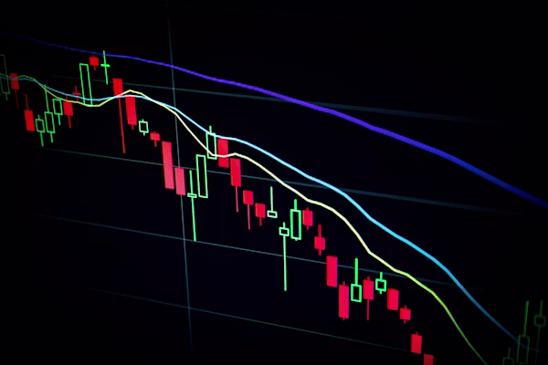 Trader analyzing stock market fluctuations on a laptop