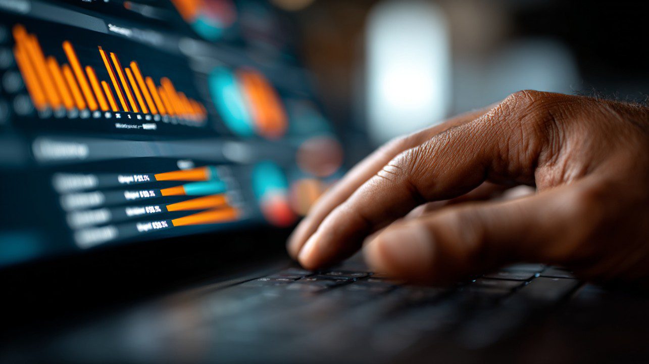 Laptop showing analytical financial graphs and data points